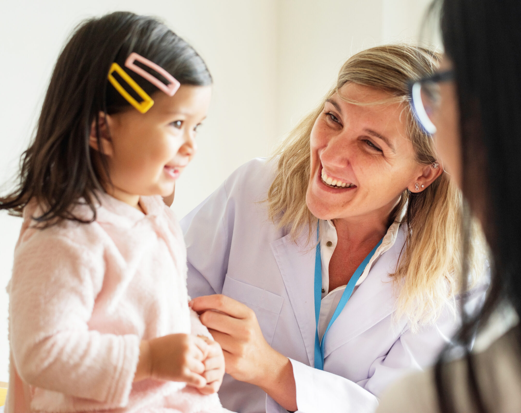 Pediatrician examining a little girl