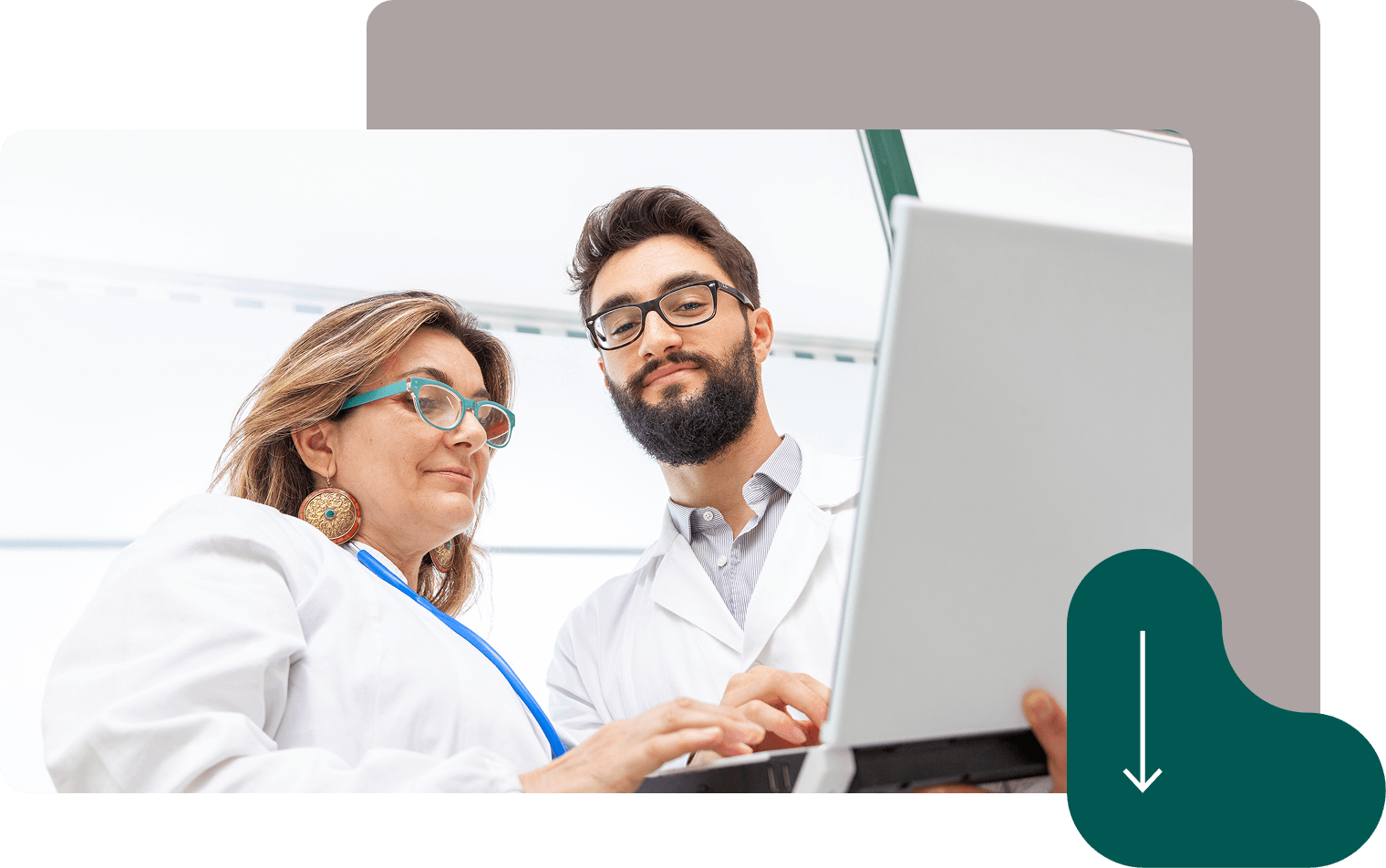 Two doctors in white coats using laptop computer for medical consultation